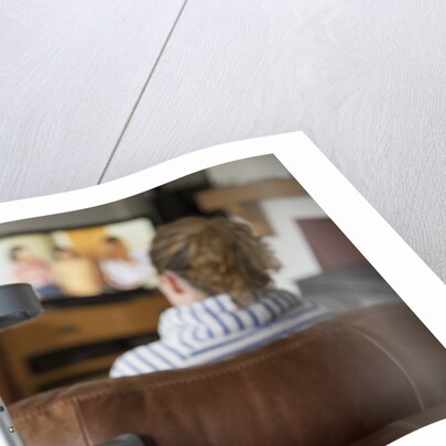 Woman watching TV with crutches by Anonymous