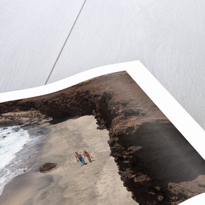Couple walking on secluded beach at Shark's cove, Lanai, Hawaii MR by Anonymous