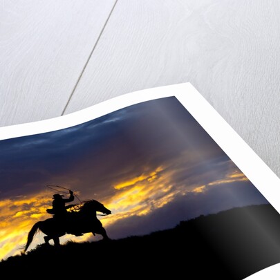 Cowboy in silhouette with sunset by Anonymous