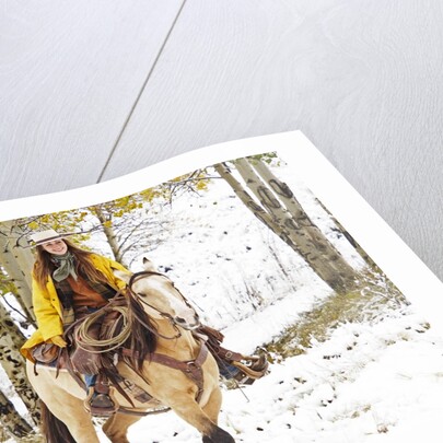 Cowgirl riding in Autumn Aspens with a fresh snowfall by Anonymous