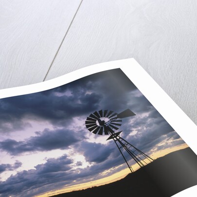 Windmill Silhouette Under Broken Clouds by Anonymous