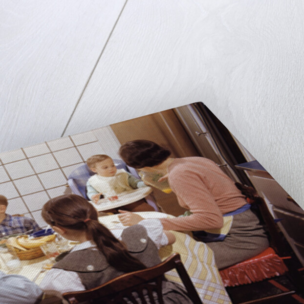 Family Eating Together at Dinner Table by Anonymous