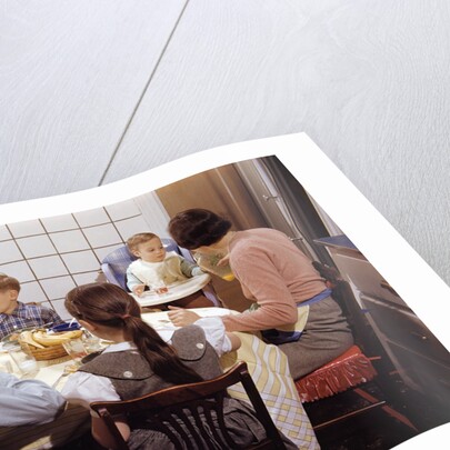 Family Eating Together at Dinner Table by Anonymous