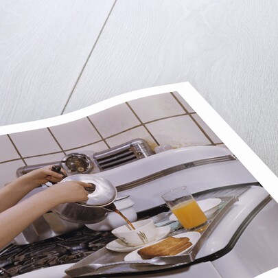 Girl Preparing Breakfast in Kitchen by Anonymous