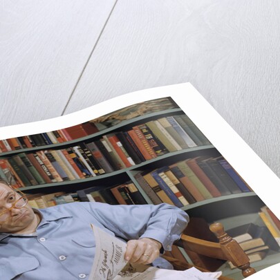 Man Holding Newspaper While Thinking by Anonymous