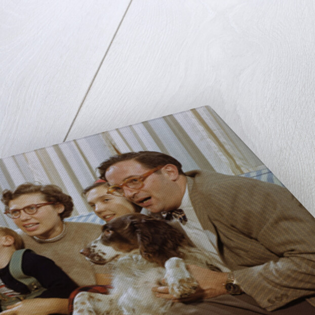 Family Sitting on Couch Together by Anonymous