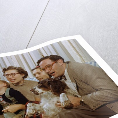 Family Sitting on Couch Together by Anonymous