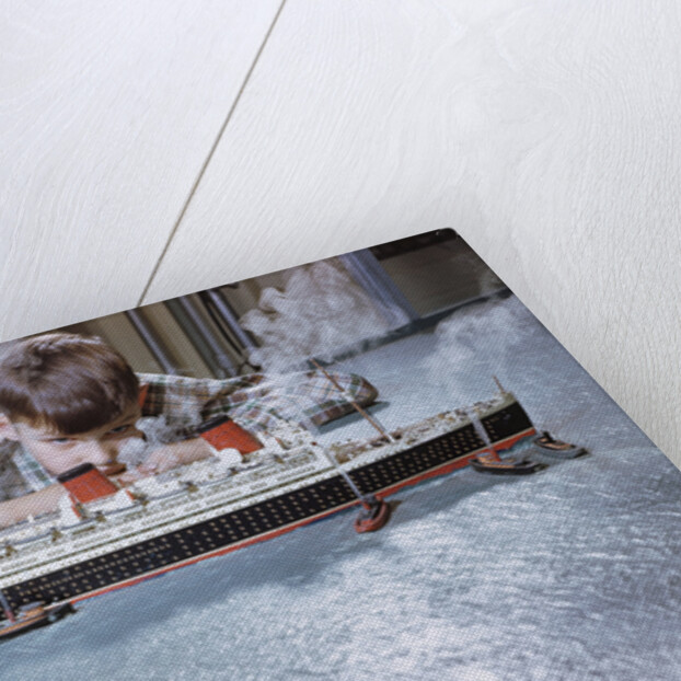 Boy Playing with Toy Ocean Liner by Anonymous