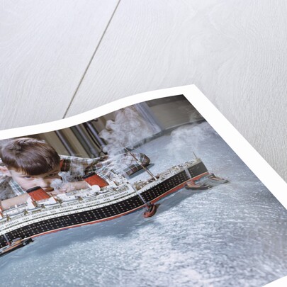 Boy Playing with Toy Ocean Liner by Anonymous