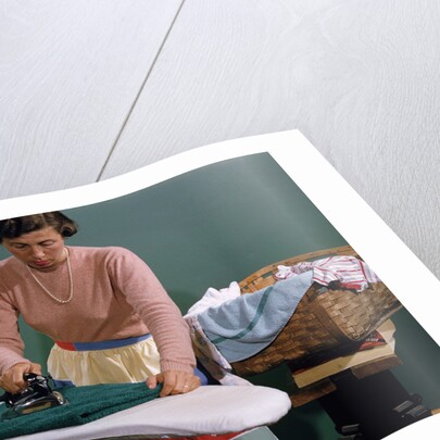 Woman Ironing at Home by Anonymous