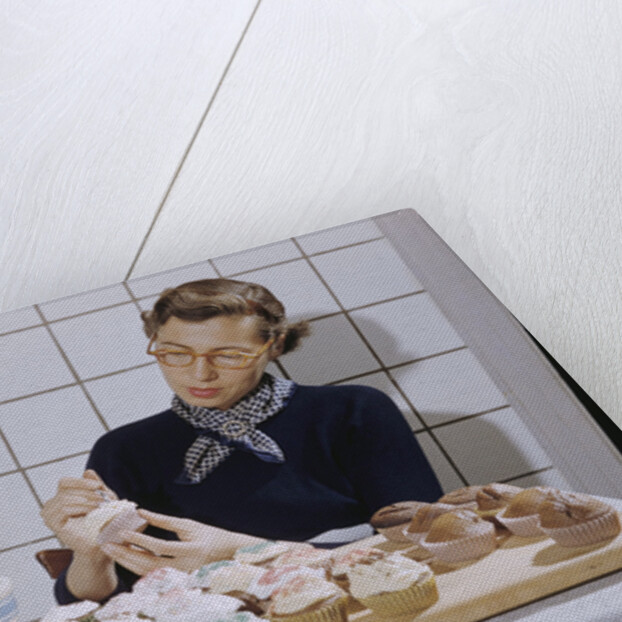 Woman Decorating Cup Cakes by Anonymous