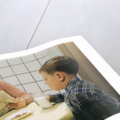 Boy Eating Cookies and Milk as Mom Reads by Anonymous