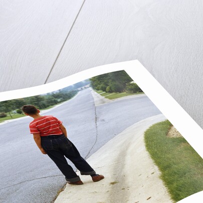 Boy Waiting on Suburban Street by Anonymous