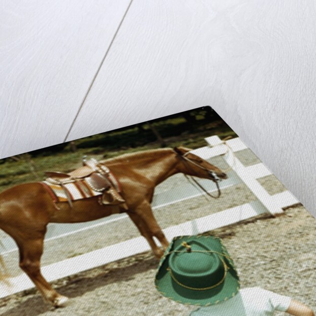 Young Cowboy Looking at Horse by Anonymous