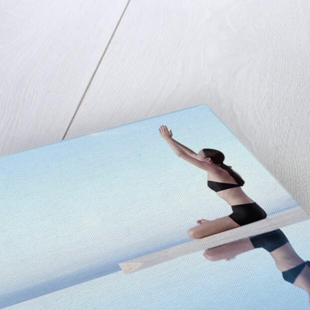 Woman Exercising on Swimming Pool Edge by Anonymous