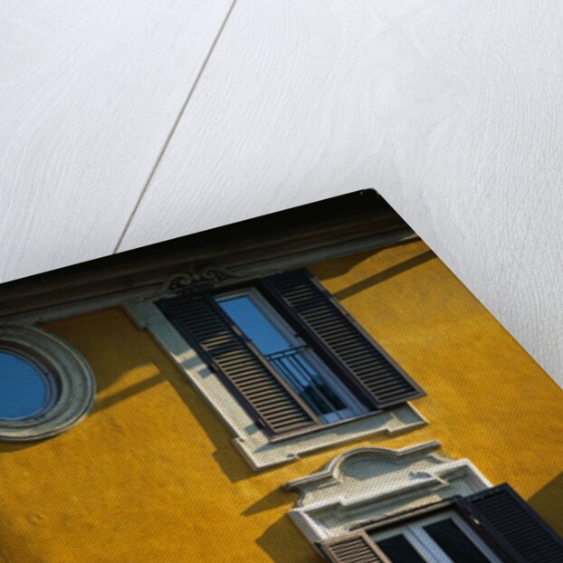 Shuttered Windows on Yellow Building by Anonymous