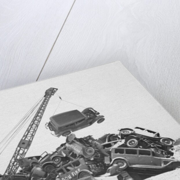 Crane Stacking Up Old Cars to be Burned in a Bonfire by Anonymous