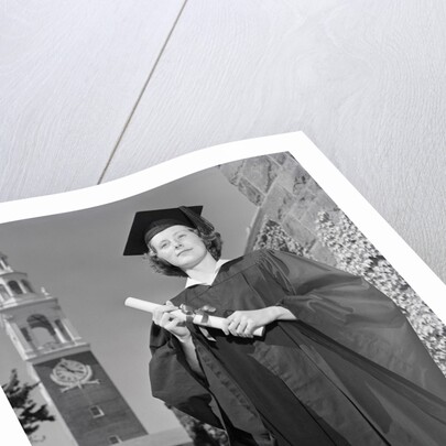 Woman in Mortarboard and Gown by Corbis