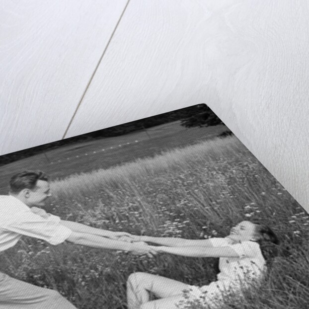 Young Couple Frolicking in Grass by Anonymous