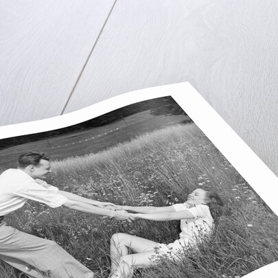 Young Couple Frolicking in Grass by Anonymous