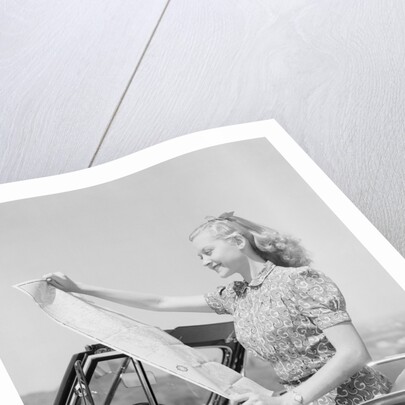 Young Woman Reading Road Map by Anonymous