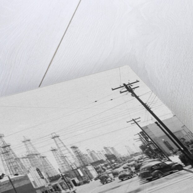 Clusters Of Oil Derricks Along Street by Anonymous