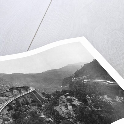 Train Traveling Over Viaduct in Mountain by Anonymous
