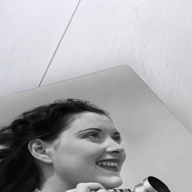 Woman Smiles as She Holds Camera by Anonymous