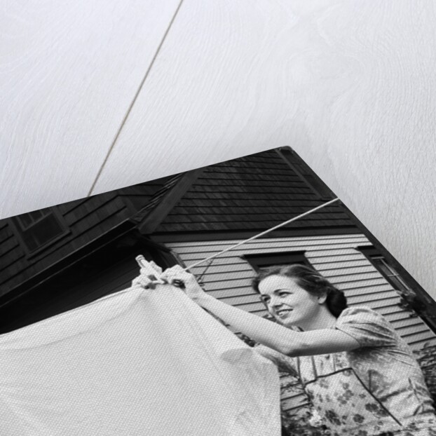 Woman Hanging Laundry Out to Dry by Anonymous