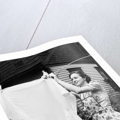Woman Hanging Laundry Out to Dry by Anonymous