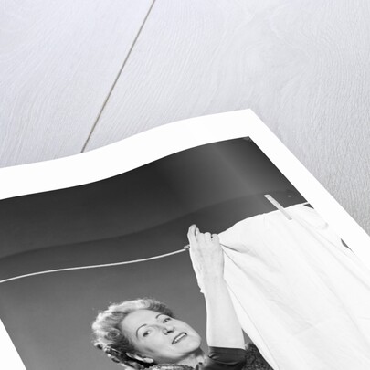 Woman Hanging Laundry by Anonymous