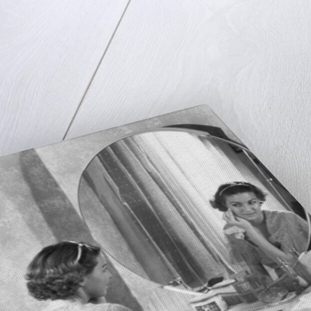 Young Woman Applying Face Cream at Vanity by Anonymous