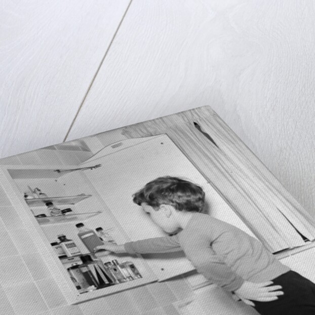 Boy Reaching into Medicine Cabinet by Anonymous