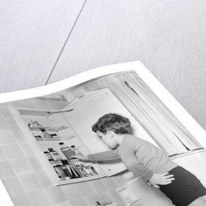 Boy Reaching into Medicine Cabinet by Anonymous