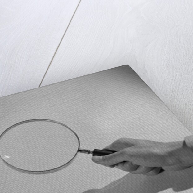 Hand Holding a Magnifying Glass by Anonymous