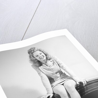 Woman Seated on Desk by Anonymous