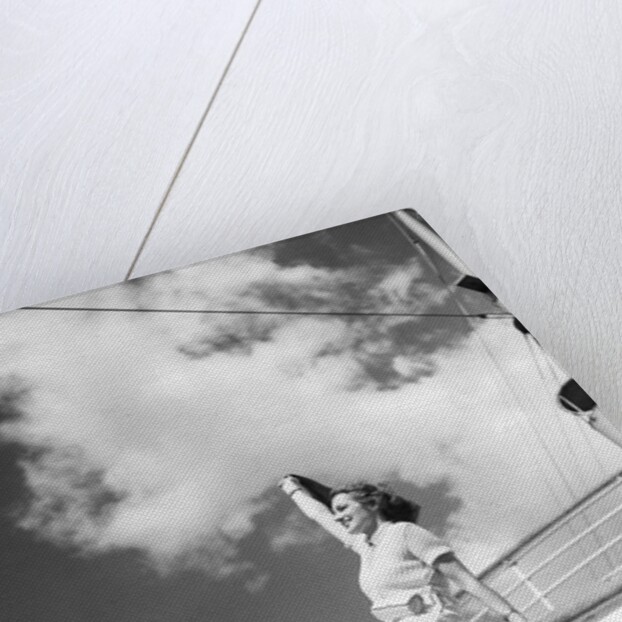 Woman Sitting on Ship Railing by Anonymous