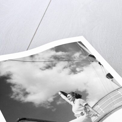 Woman Sitting on Ship Railing by Anonymous