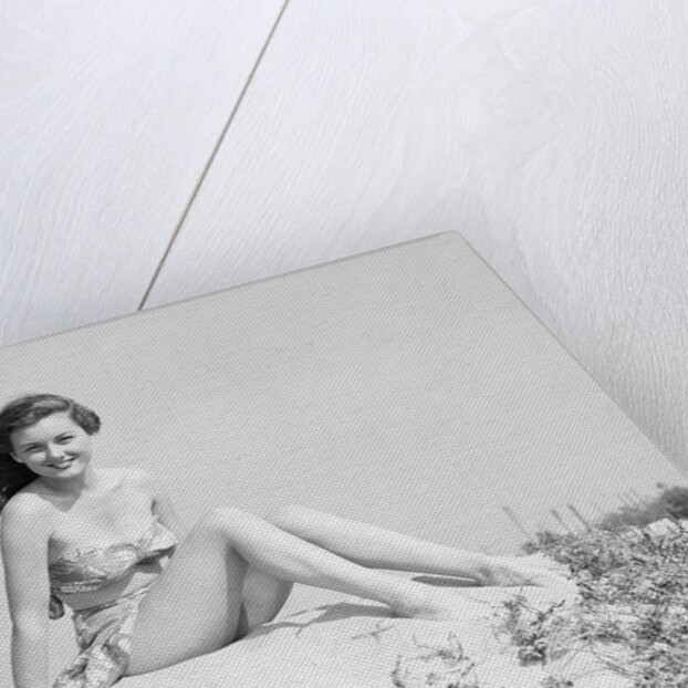 Young Woman Seated on Sand Dune by Anonymous