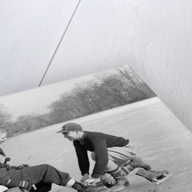 Man Lacing a Woman's Ice Skate by Anonymous
