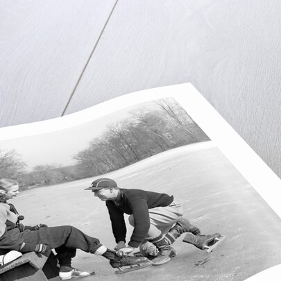 Man Lacing a Woman's Ice Skate by Anonymous