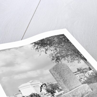 Girl Kneels at Headstone by Anonymous