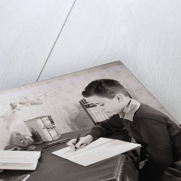 Boy Writing at Desk by Anonymous