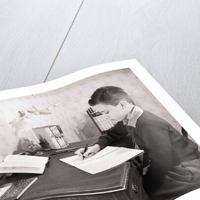 Boy Writing at Desk by Anonymous