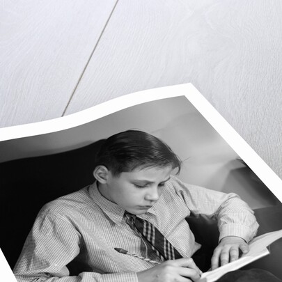 Seated Boy Doing Homework by Anonymous