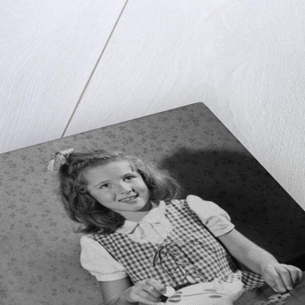 Girl Putting Money In Piggy Bank by Anonymous