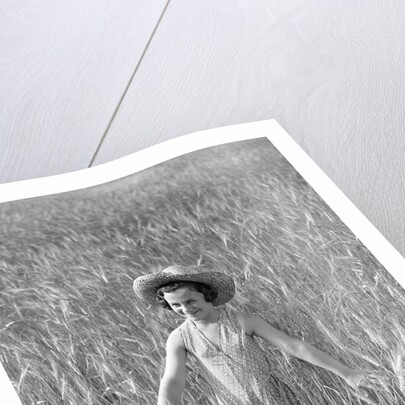 Girl Standing in Wheat Field by Anonymous