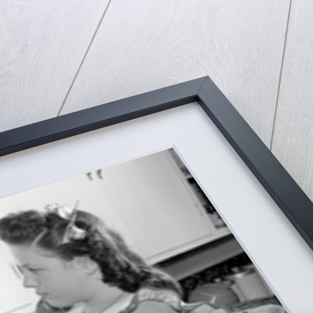 Woman Putting Dishes In Cabinet by Anonymous