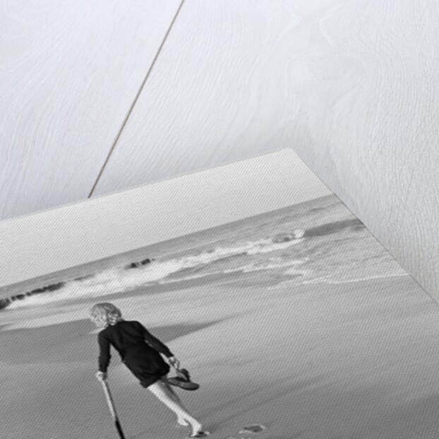 Woman Walking on Beach Leaving Footprints by Anonymous