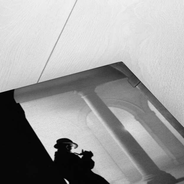 Silhouette of Man Lighting Pipe by Anonymous